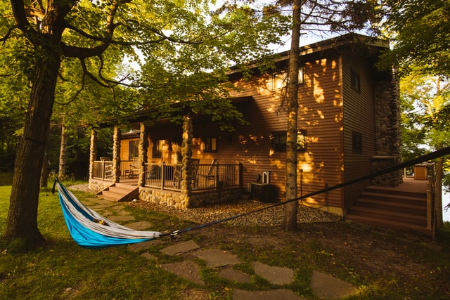 cabin in the woods with hammock in front