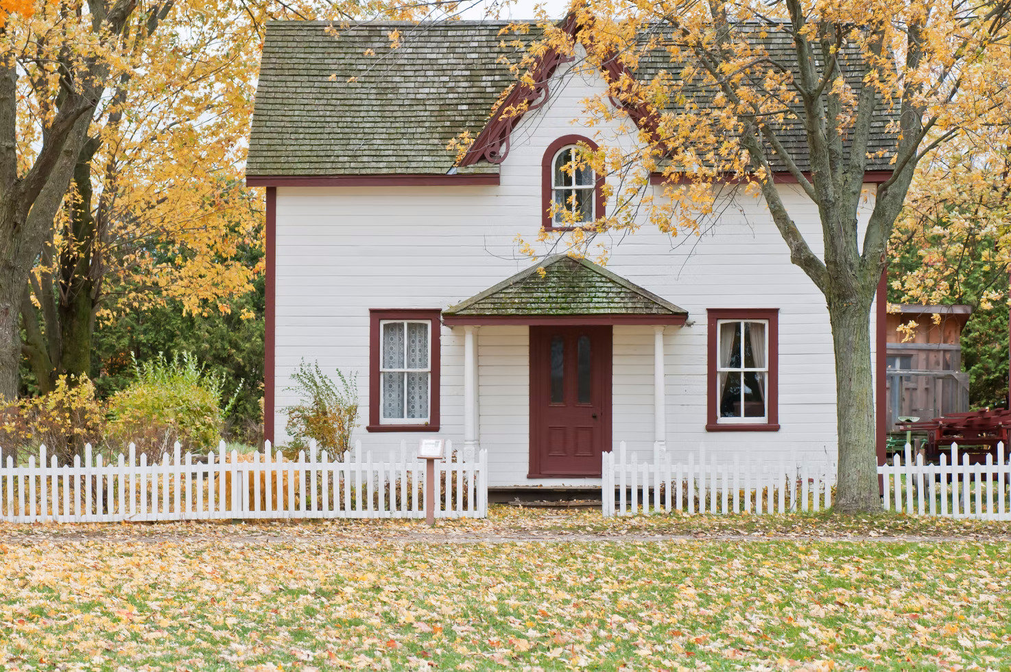 quaint house surrounding by fallen leaves