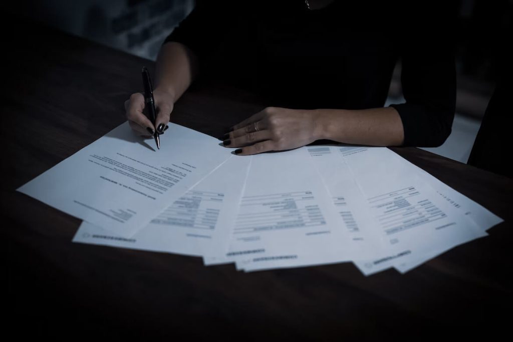 person signing paperwork for a home equity conversion mortgage