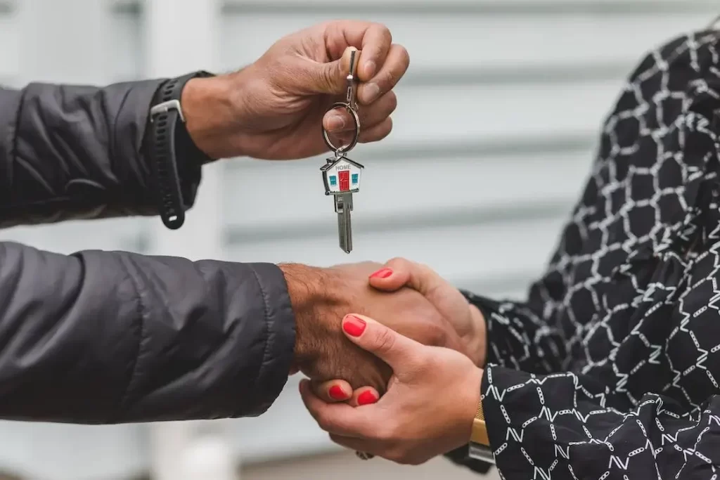 two people shaking hands and exchanging house key