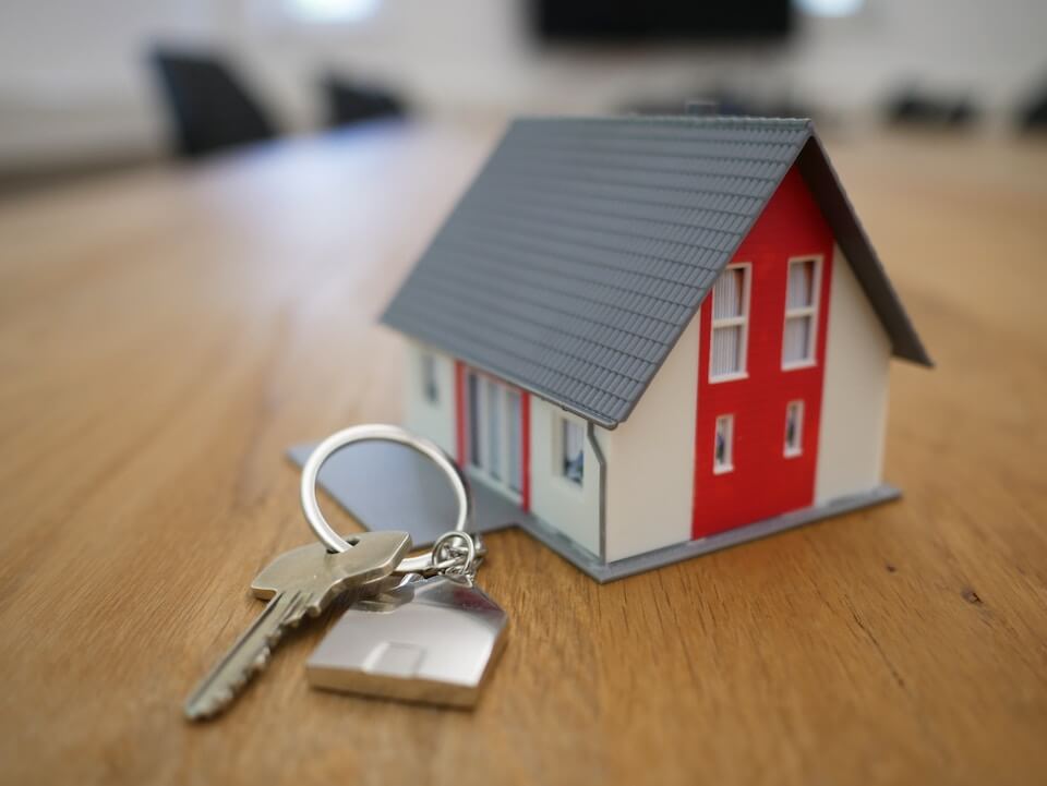 model house next to a set of house keys